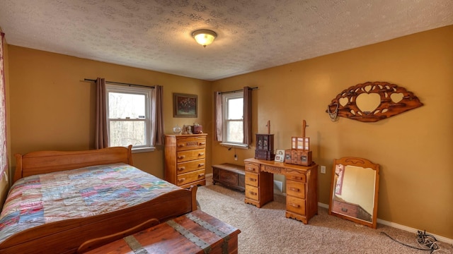 bedroom with light colored carpet, a textured ceiling, and baseboards