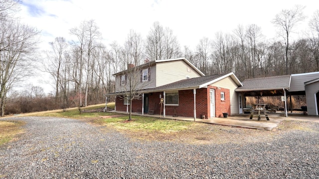 view of property exterior with brick siding and a chimney