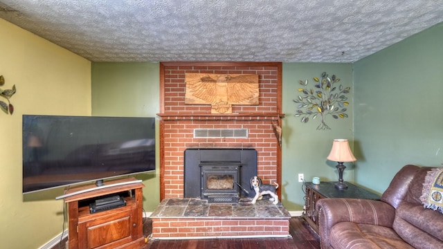 living room featuring wood finished floors, visible vents, and a textured ceiling