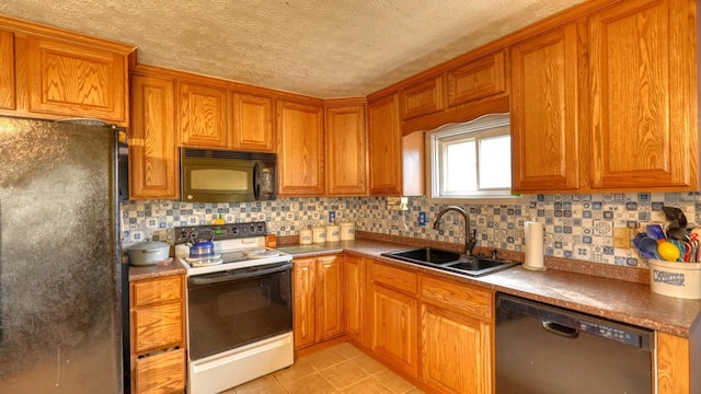 kitchen featuring a sink, brown cabinets, black appliances, and light tile patterned flooring