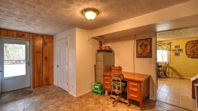 home office with baseboards and a textured ceiling