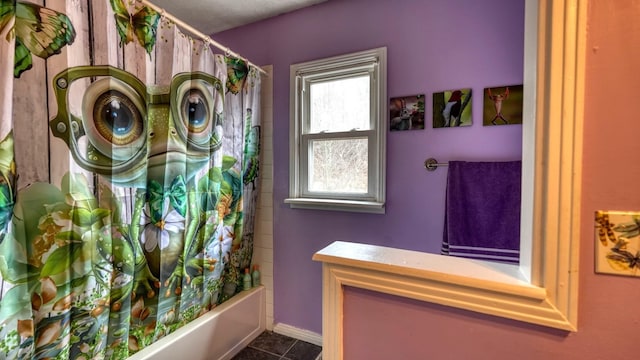 full bathroom featuring tile patterned flooring, shower / tub combo, and baseboards