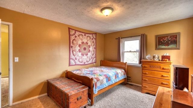 carpeted bedroom featuring baseboards and a textured ceiling