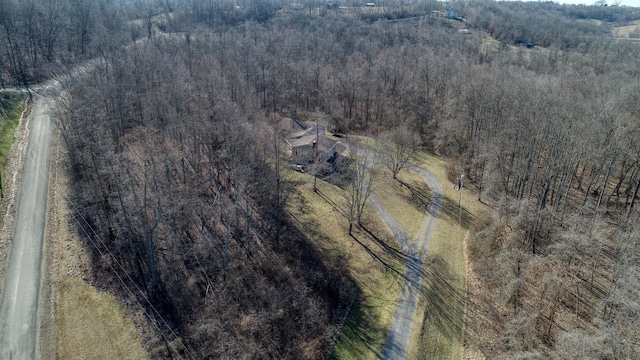 birds eye view of property with a view of trees