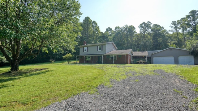 225 Homestead Dr, New Concord, OH 43762 - view of front of house featuring an attached garage, a chimney, driveway, a front lawn, and covered porch