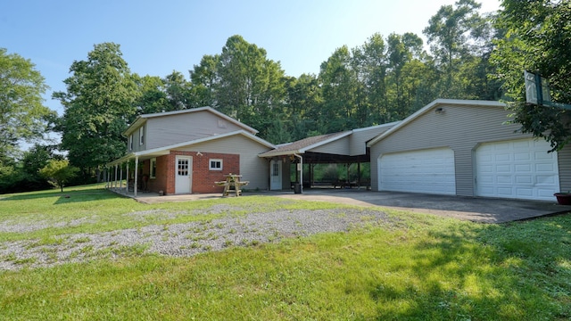 225 Homestead Dr, New Concord, OH 43762 - view of front of property featuring a front yard, driveway, brick siding, an attached garage, and a carport