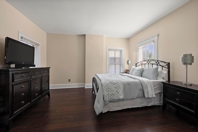 bedroom featuring dark wood-style floors and baseboards