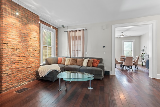 living room featuring wood finished floors, visible vents, and baseboards