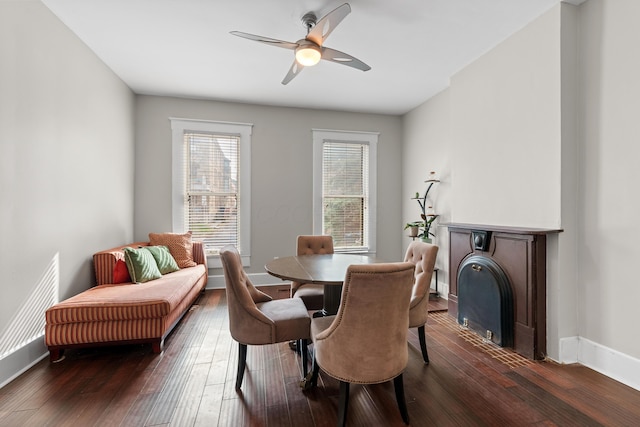 dining room featuring dark wood-style floors, baseboards, and a ceiling fan