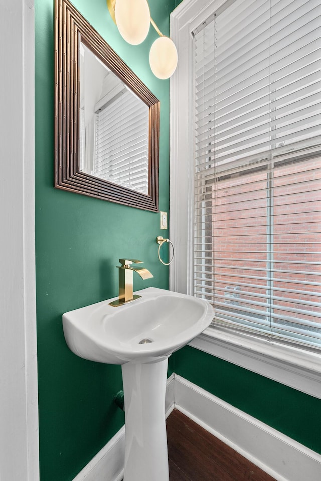 bathroom with baseboards and wood finished floors