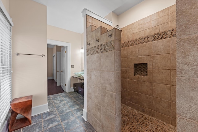 full bathroom with a wealth of natural light, baseboards, and walk in shower