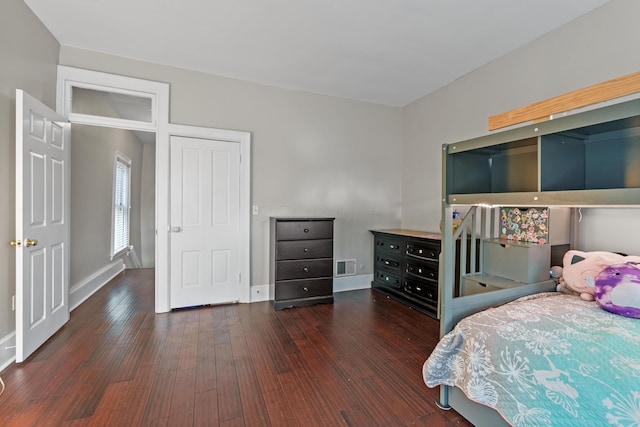 bedroom with wood-type flooring, visible vents, and baseboards