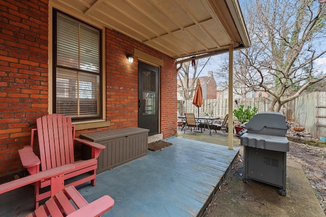 view of patio featuring outdoor dining area, fence, and grilling area