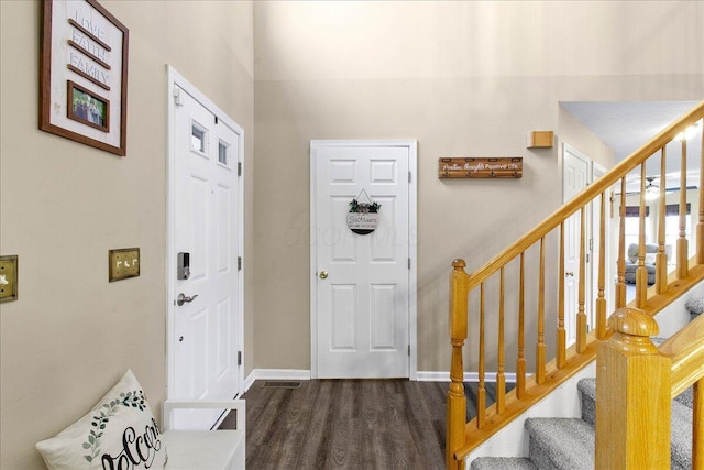 entrance foyer featuring baseboards, stairway, and wood finished floors