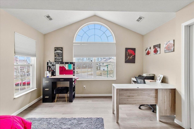 office area with baseboards, visible vents, vaulted ceiling, and wood finished floors