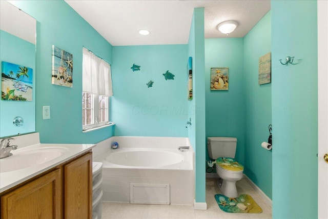 bathroom featuring toilet, vanity, tile patterned flooring, baseboards, and a bath