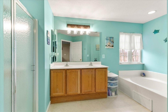 full bath with double vanity, a garden tub, a shower stall, and a sink