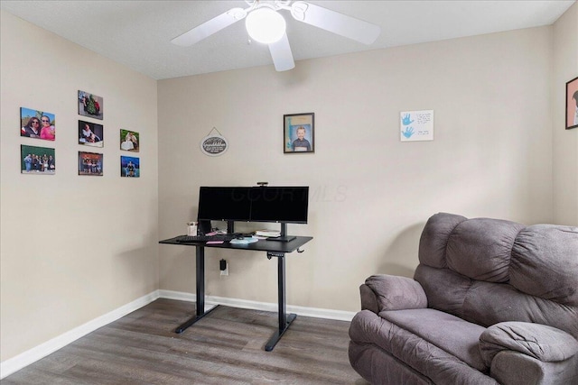 office area with a ceiling fan, baseboards, and wood finished floors