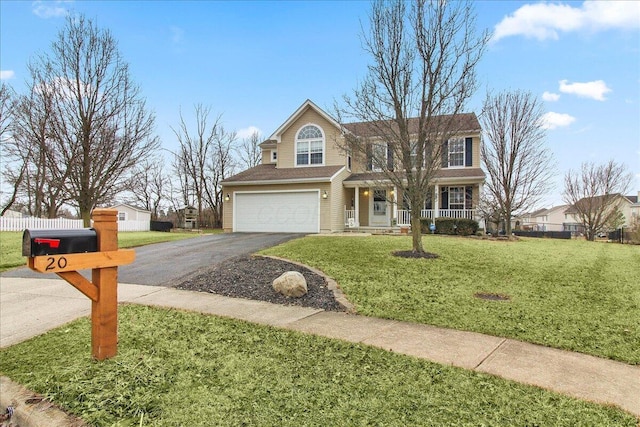 view of front of house with aphalt driveway, covered porch, an attached garage, fence, and a front lawn