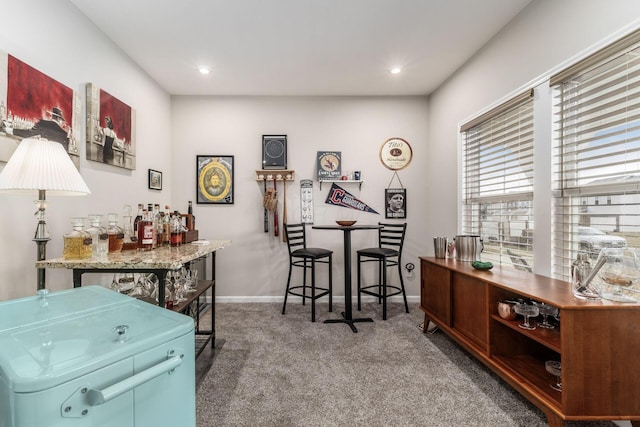 interior space with recessed lighting, a dry bar, and baseboards