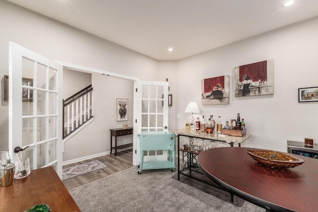 interior space with recessed lighting, wood finished floors, baseboards, french doors, and stairway