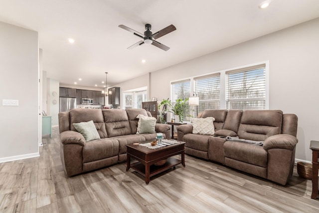 living room with light wood-style flooring, baseboards, a ceiling fan, and recessed lighting