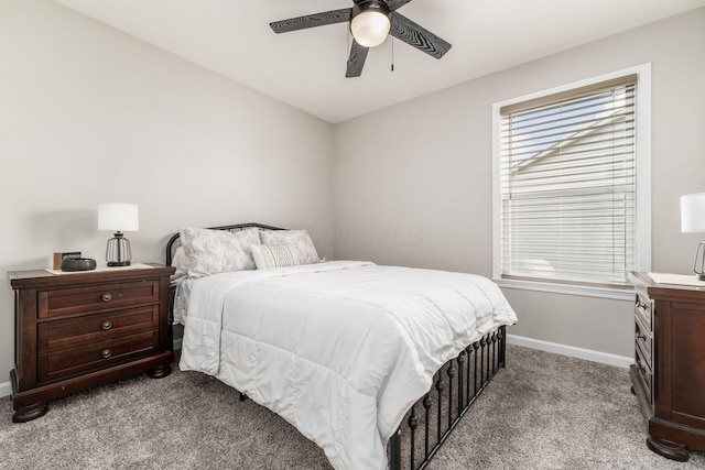 bedroom with a ceiling fan, light colored carpet, and baseboards