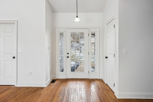 entrance foyer featuring wood-type flooring, visible vents, and baseboards