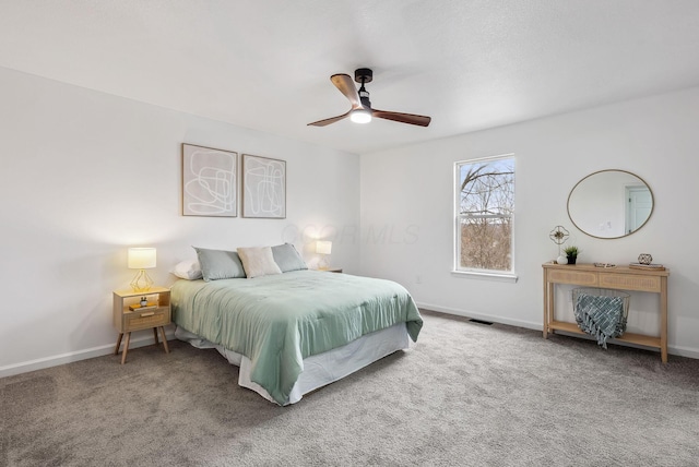 carpeted bedroom with a ceiling fan, visible vents, and baseboards