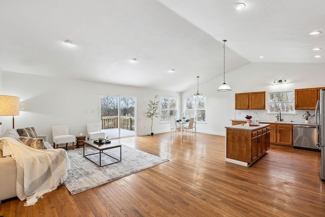 living area featuring high vaulted ceiling, recessed lighting, baseboards, and hardwood / wood-style flooring