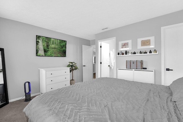 carpeted bedroom featuring baseboards and visible vents