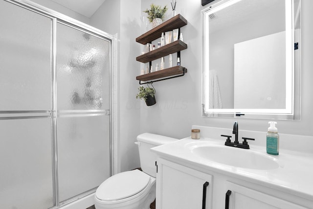 full bath with a stall shower, vanity, and toilet