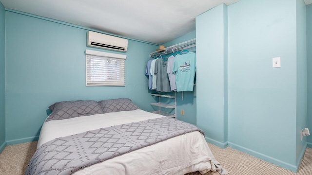 carpeted bedroom with baseboards and an AC wall unit