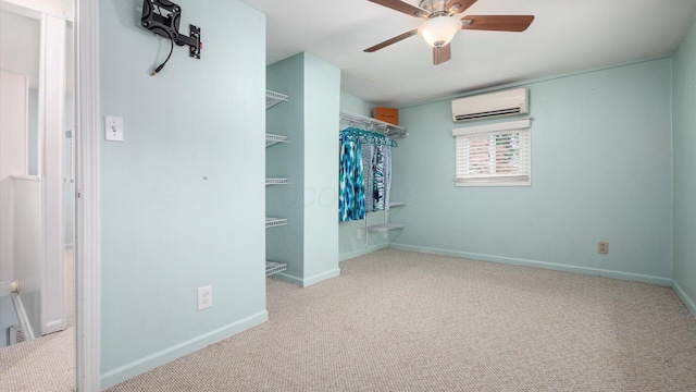 unfurnished bedroom featuring carpet floors, an AC wall unit, and baseboards