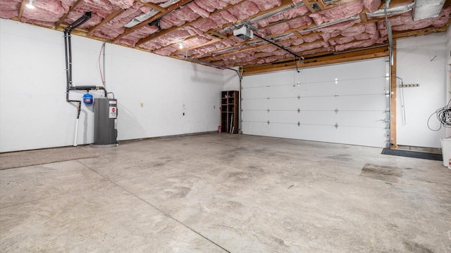 garage with a garage door opener and water heater