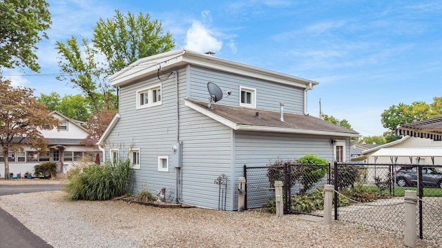 rear view of property featuring fence