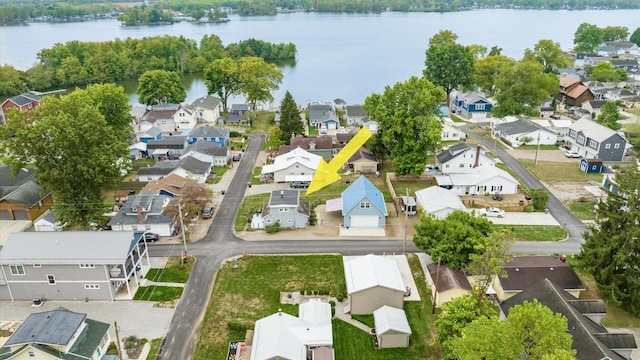 drone / aerial view with a water view and a residential view