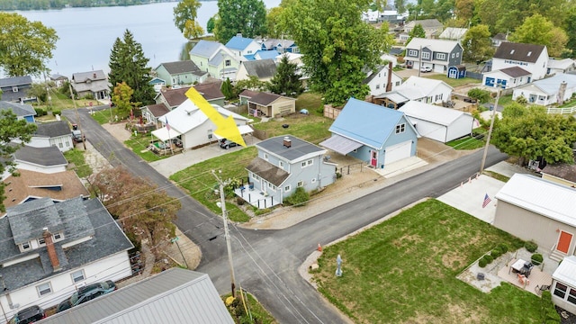 drone / aerial view with a water view and a residential view