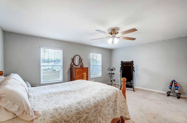 bedroom featuring baseboards, a ceiling fan, and light colored carpet