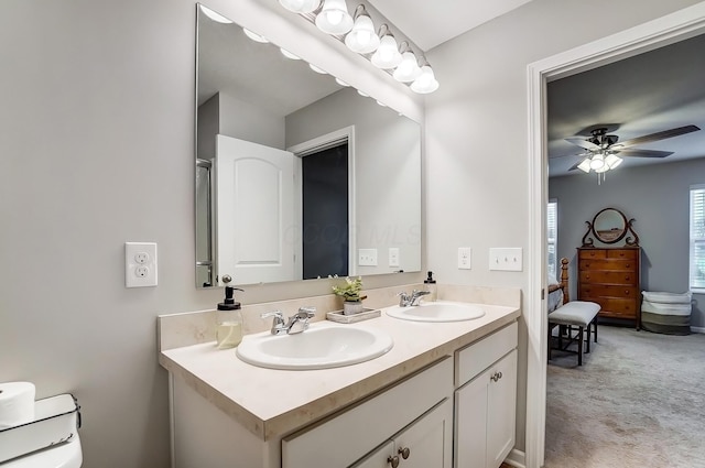 full bath with a ceiling fan, a sink, and double vanity