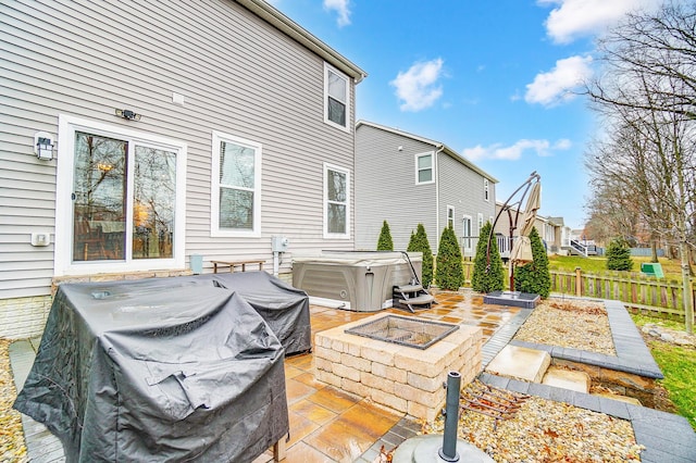 exterior space with a vegetable garden, fence, and a hot tub