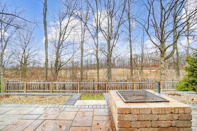 view of patio with an outdoor fire pit and a fenced backyard