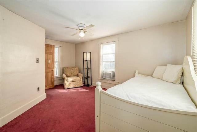 bedroom with baseboards, a ceiling fan, and dark carpet