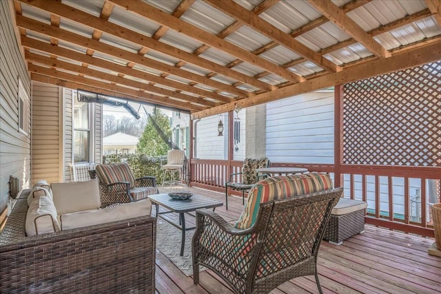 wooden terrace with an outdoor living space