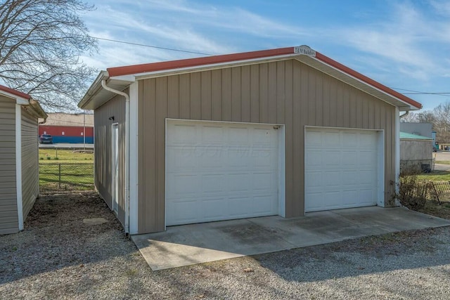 detached garage featuring fence