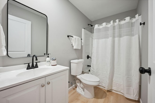 full bathroom featuring toilet, shower / bathtub combination with curtain, wood finished floors, and vanity