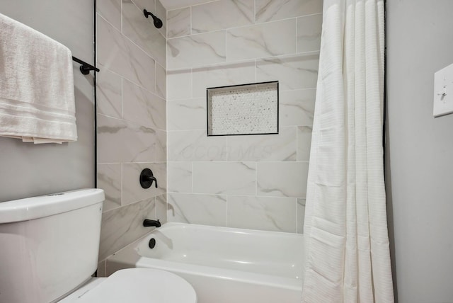 bathroom featuring shower / bath combo with shower curtain and toilet