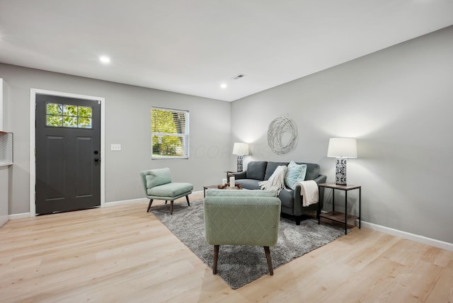 living area featuring recessed lighting, light wood-type flooring, and baseboards