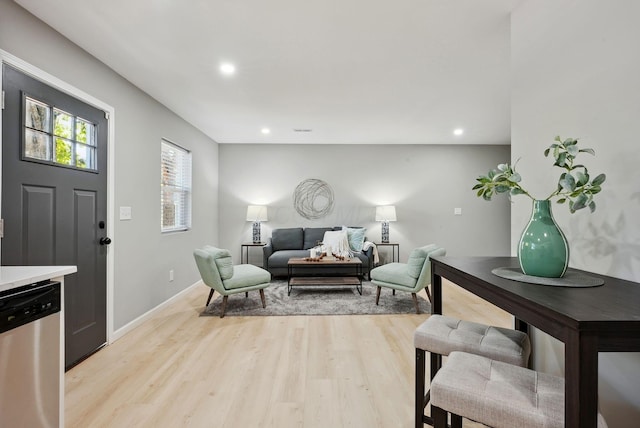 living room featuring recessed lighting, light wood-style flooring, and baseboards