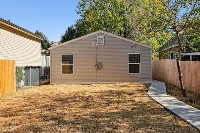 view of side of home with a fenced backyard